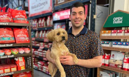 Agri Feed Pet Supply owner holding dog inside of the store